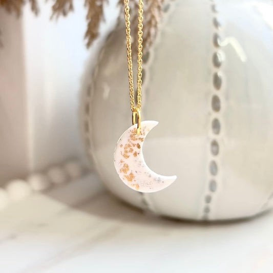 Moon necklace with silver and gold leaf on an 18inch gold plated chain. Handmade using polymer clay