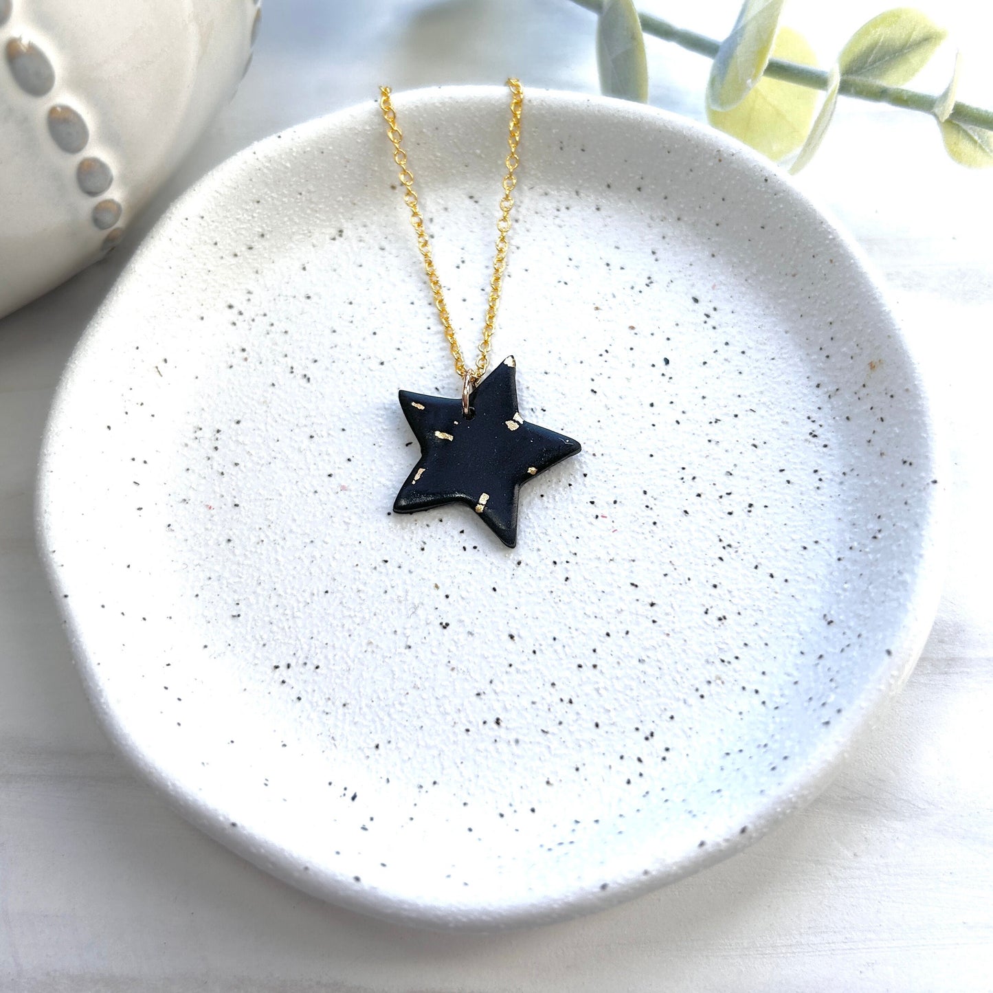 Stunning black and gold polymer clay star necklace on an 18 inch gold plated chain
