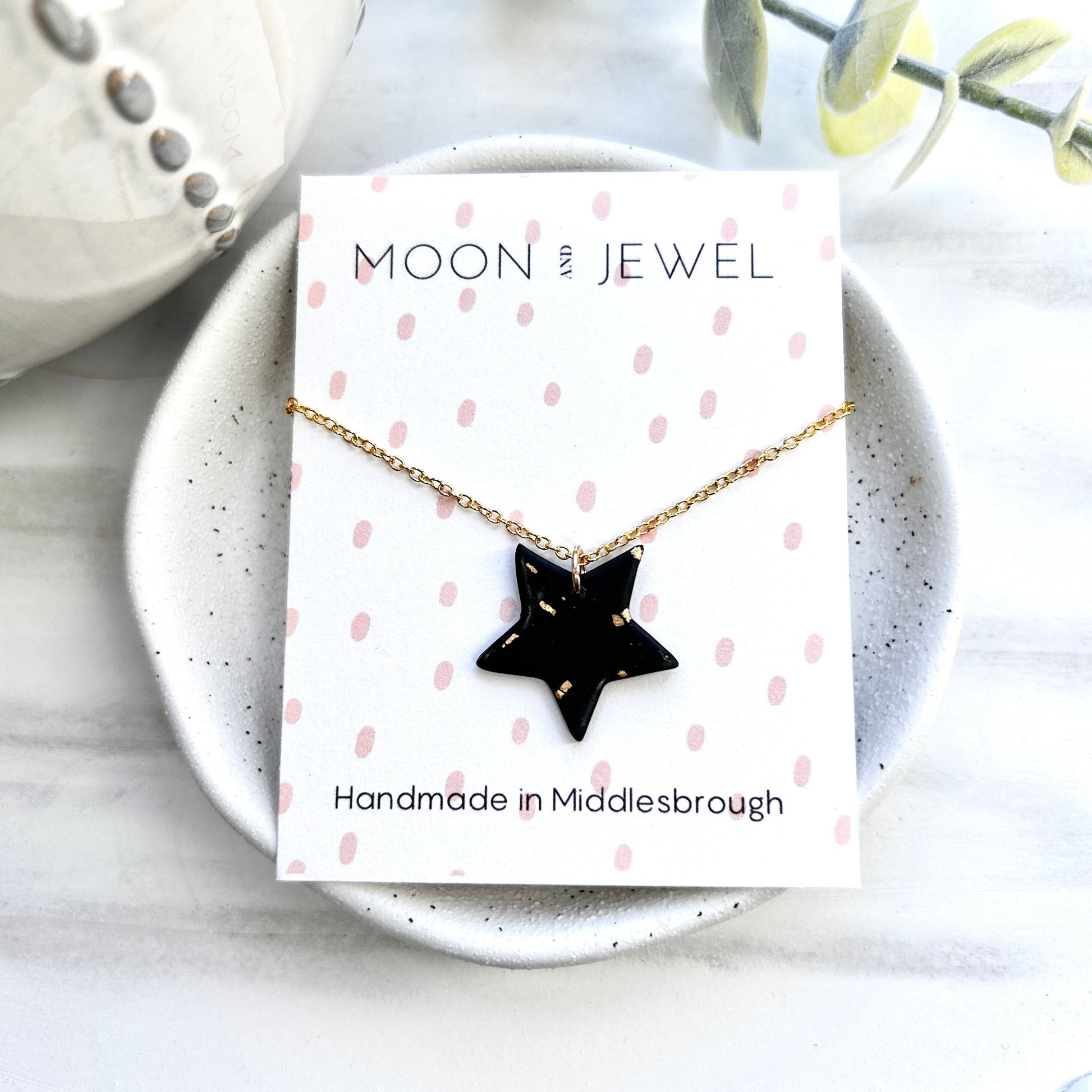 Stunning black and gold polymer clay star necklace on an 18 inch gold plated chain