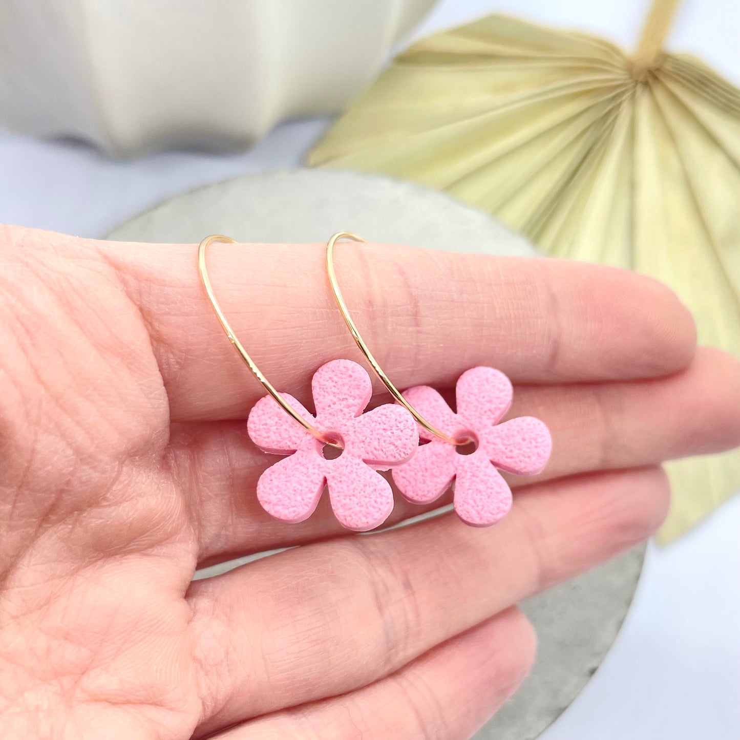 Handmade, bright pink flower polymer clay earrings on a 25mm gold coloured hoop